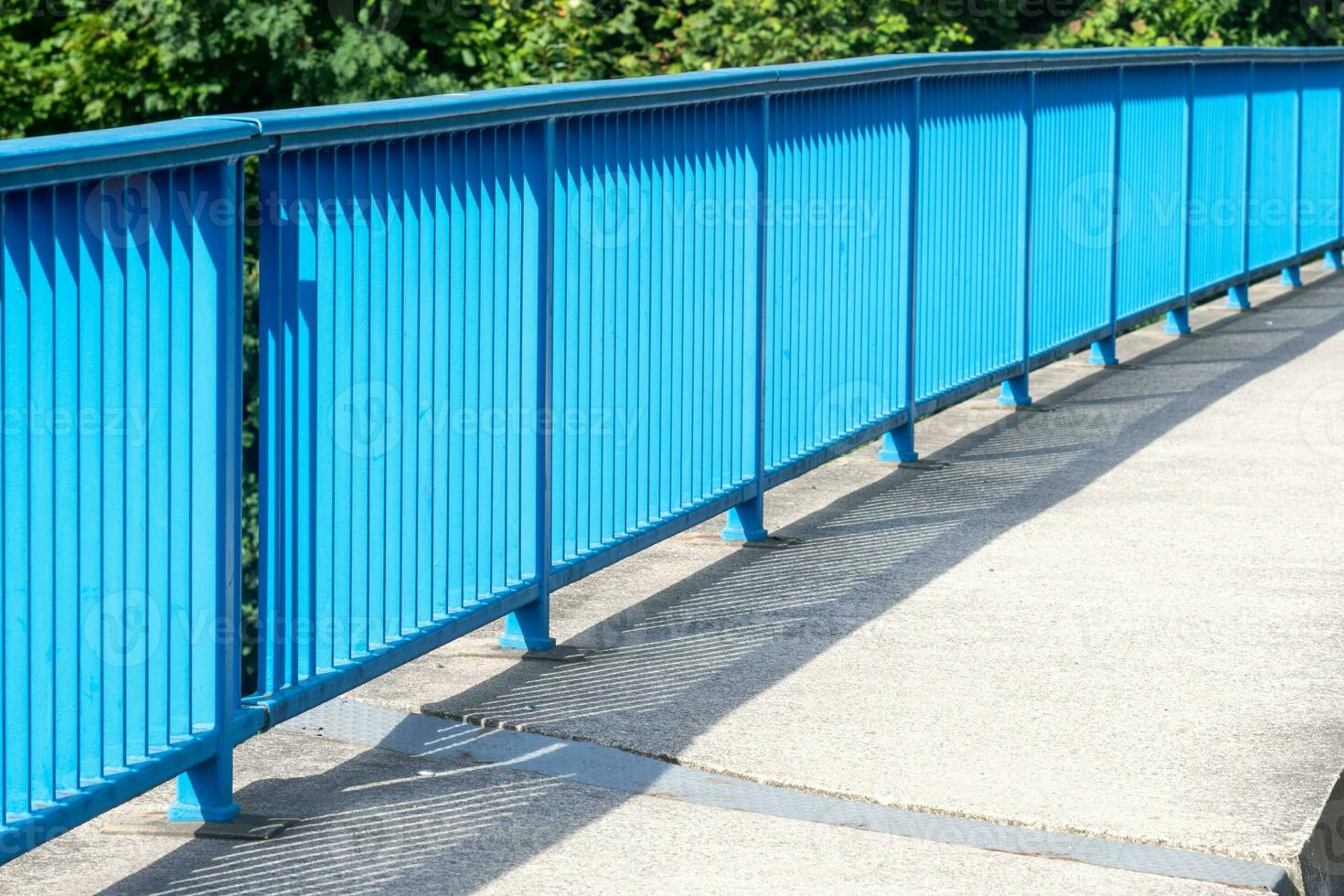 blue bridge railing in the sun photo