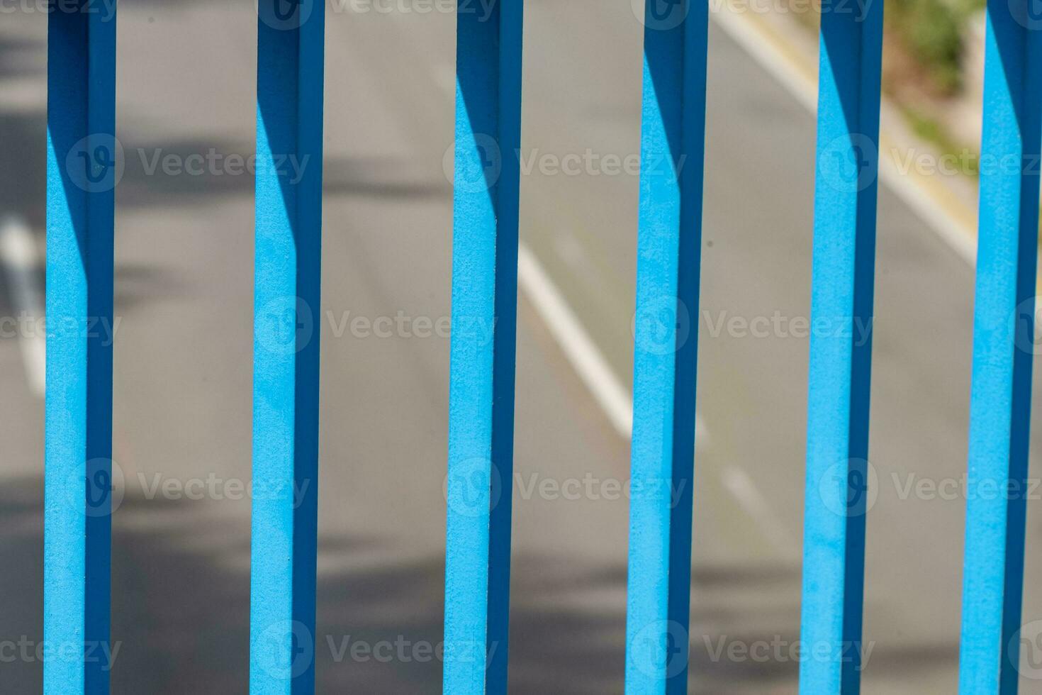 blue bridge railing in the sun photo