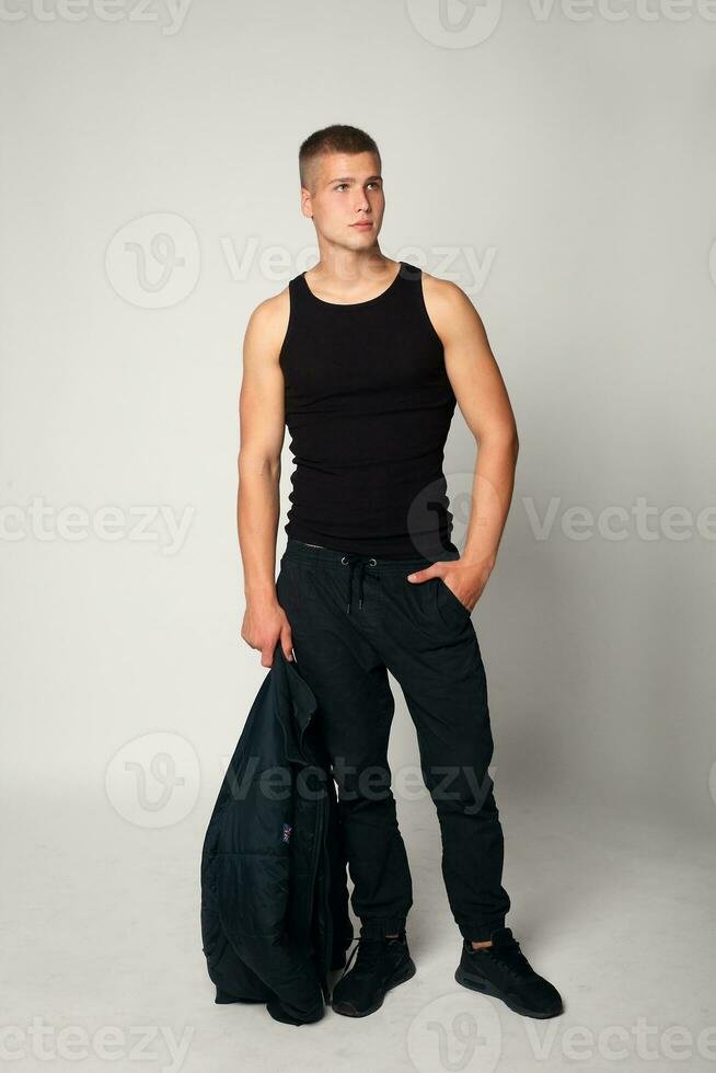 Expressive young stylish man in black t-shirt photo