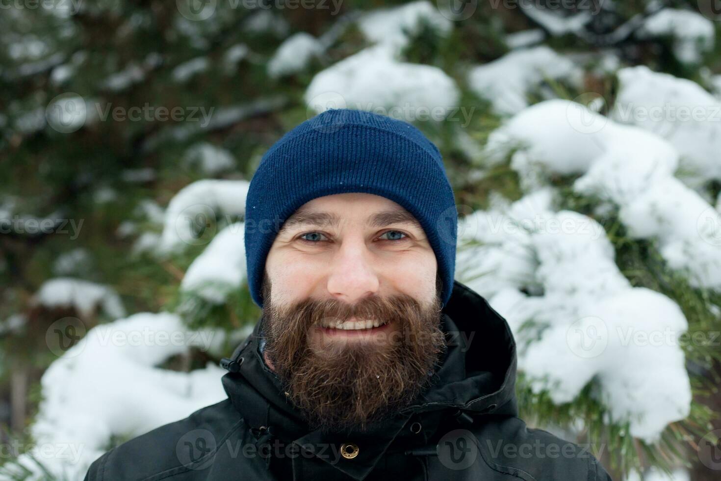 bearded man in winter hat smiling portrait extreme photo