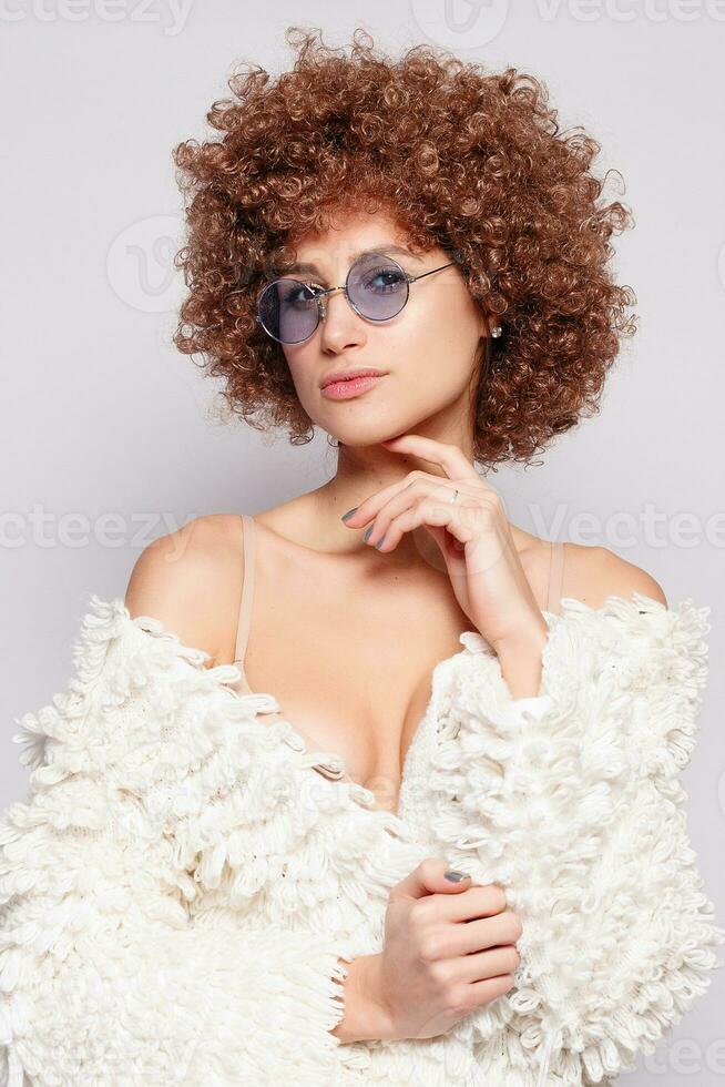 Portrait of smiling young woman with afro hairstyle photo