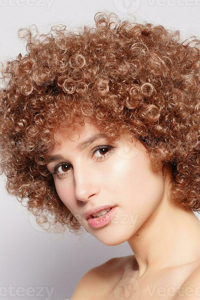 Portrait of smiling young woman with afro hairstyle photo