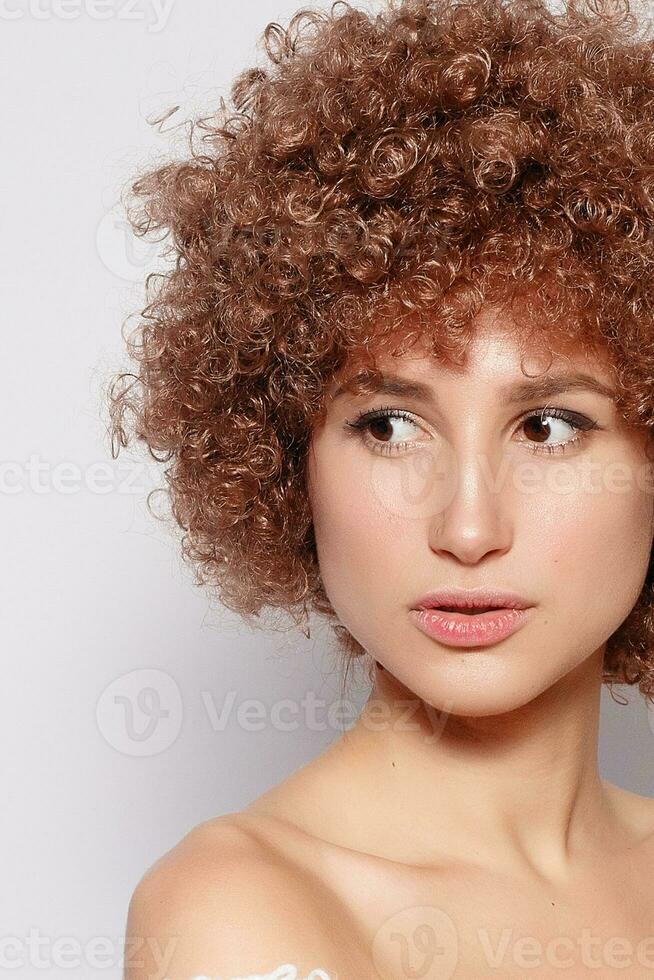Portrait of smiling young woman with afro hairstyle photo