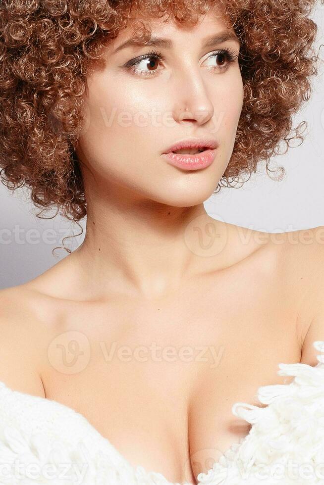 Portrait of smiling young woman with afro hairstyle photo