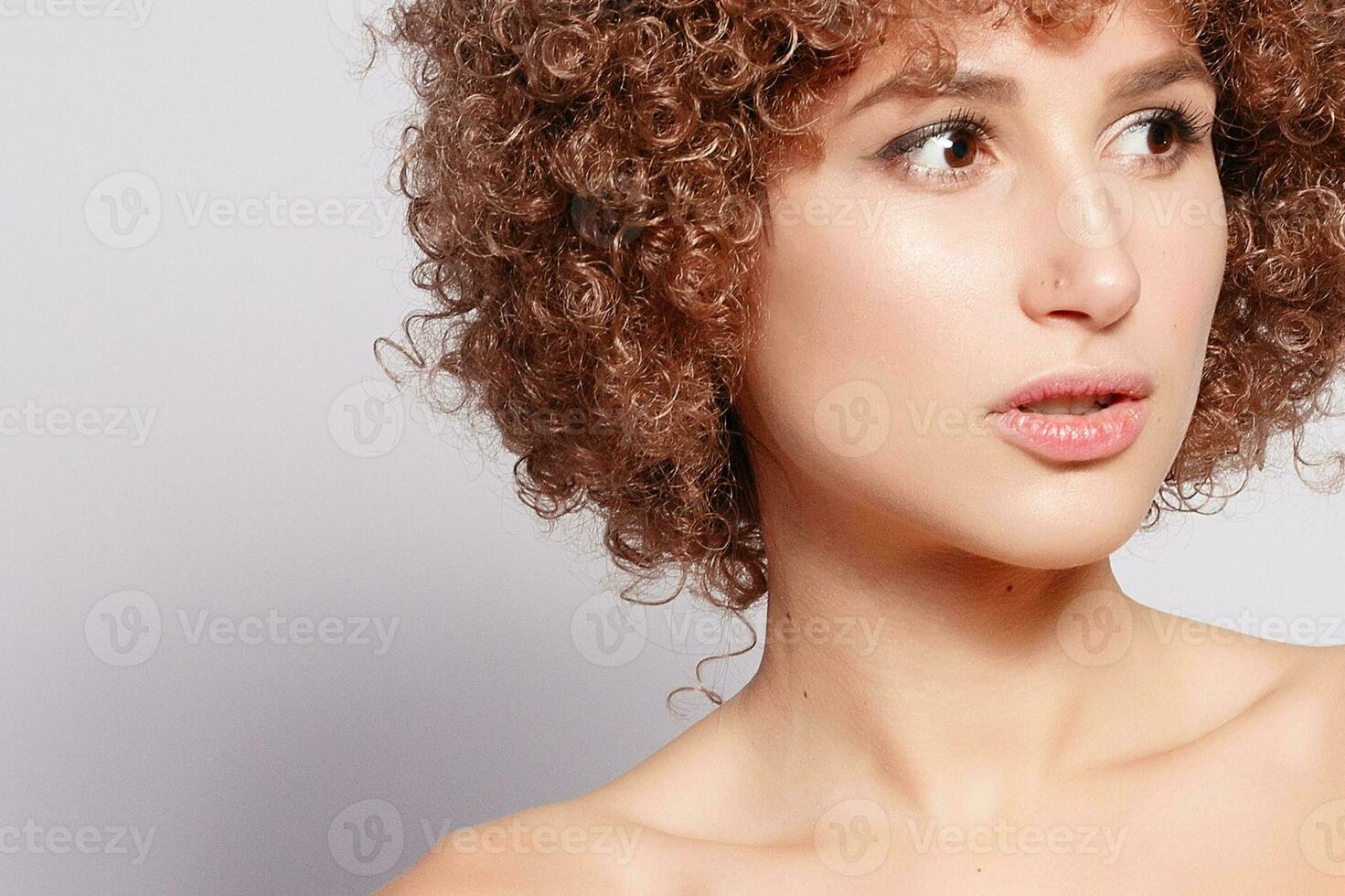 Portrait of smiling young woman with afro hairstyle photo