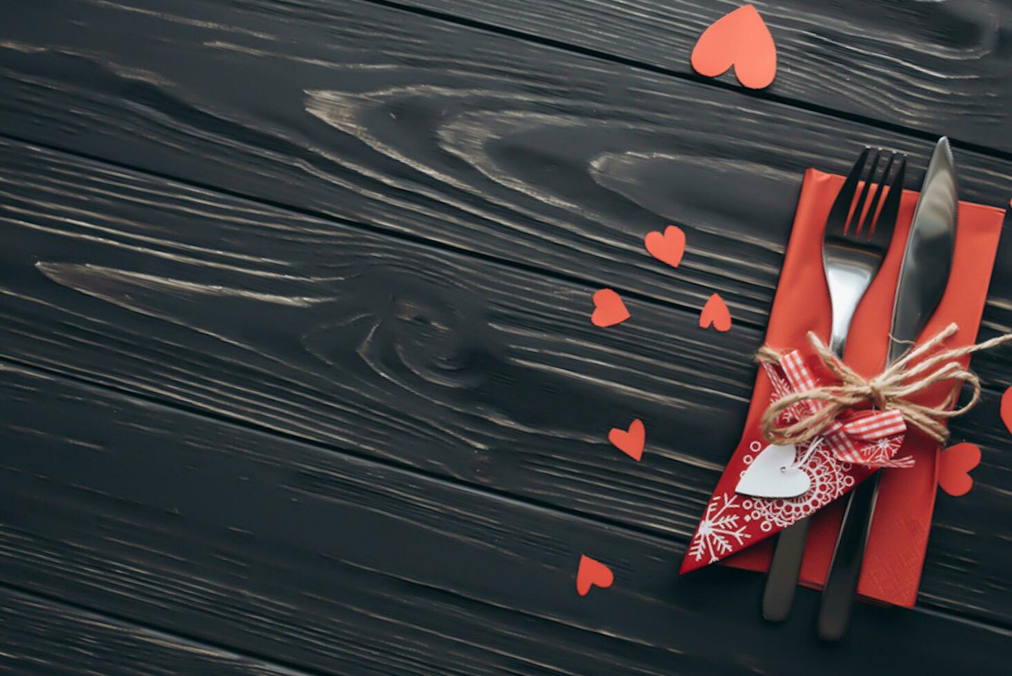 Valentines day concept. Hand make yarn red heart beside wooden block calendar set on Valentines date 14 February on table and bright room background. Happy valentine day. photo
