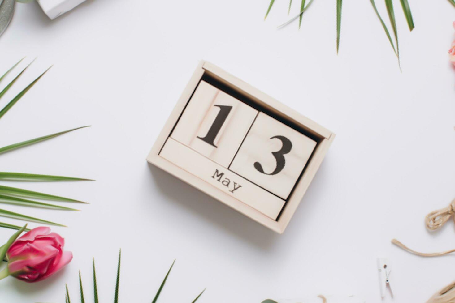 Valentines day concept. Hand make yarn red heart beside wooden block calendar set on Valentines date 14 February on table and bright room background. Happy valentine day. photo