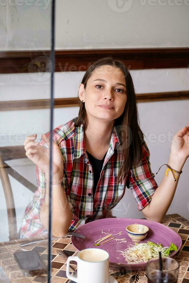 Caucasian woman in casual clothes having lunch in cafe. photo