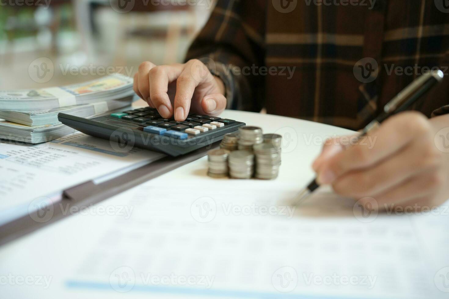 Saving money. Businessman Accountant verify growing business and saving money stacking coins with calculator. Accountancy Concept photo