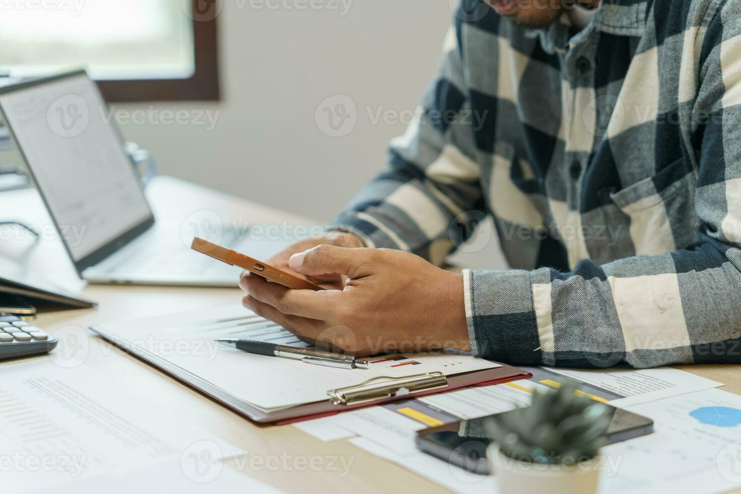 Attractive confident Hispanic Business man using laptop computer and professional working investor start up project business planning in office photo
