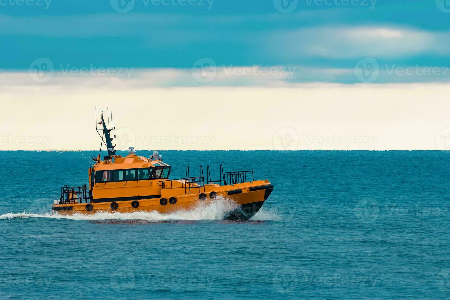 Orange pilot ship moving fast in Baltic sea. Europe photo