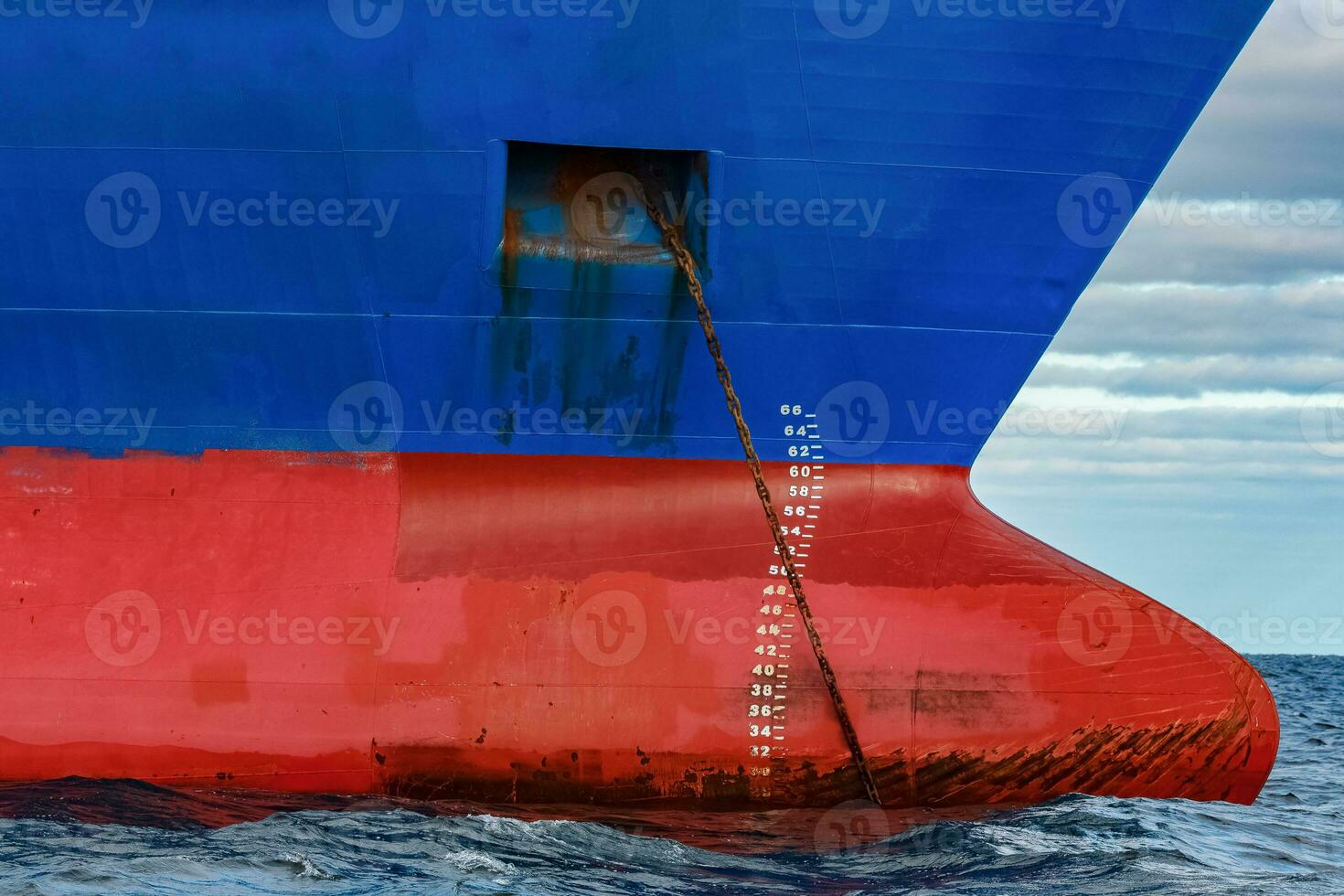 Blue cargo ship moored in still Baltic sea water photo