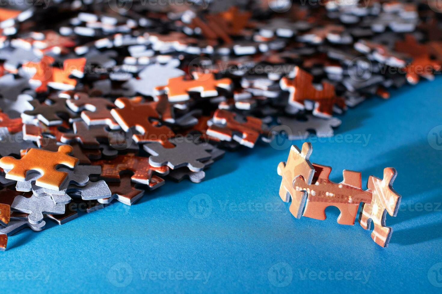 Mixed Peaces of a Colorful Jigsaw Puzzle Lie on the Blue Background Strategy and Solving Problem Concept photo