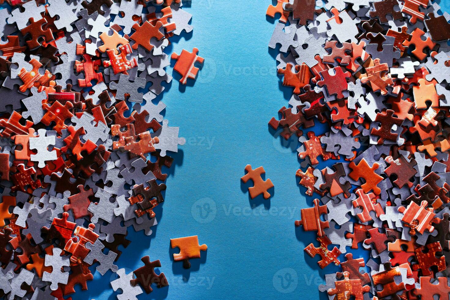 Mixed Peaces of a Colorful Jigsaw Puzzle Lie on the Blue Background Strategy and Solving Problem Concept photo