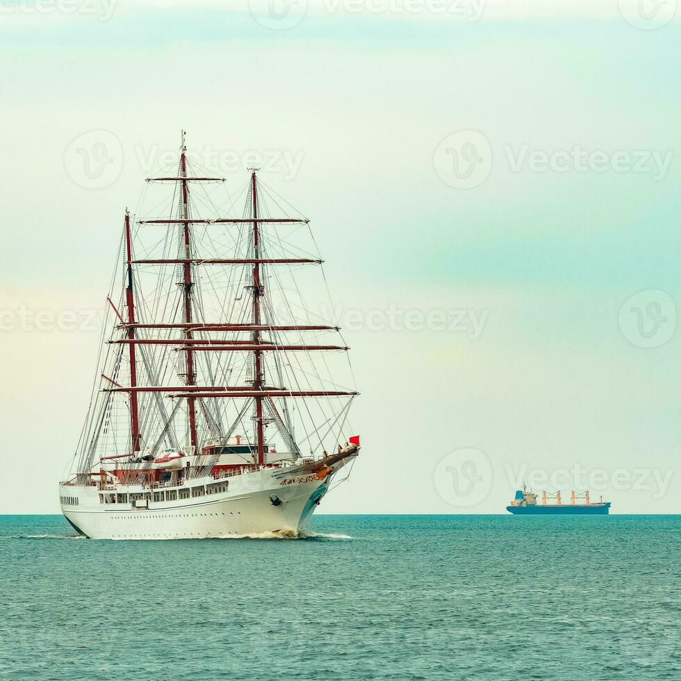 Big white sailing ship with three mast moving to the Riga port photo