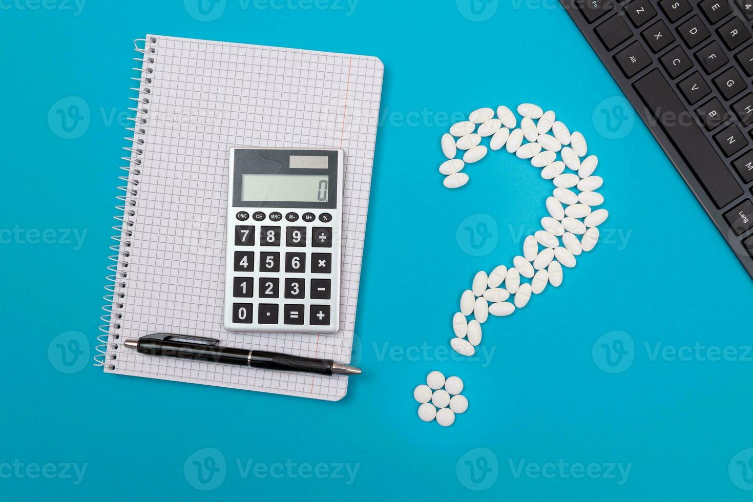 Treatment Costs and Budget. Question Mark Made from White Pills and Tablets with Calculator and Notepad, Lying on Blue Background. Global Pharmaceutical Industry and Medicinal Products photo