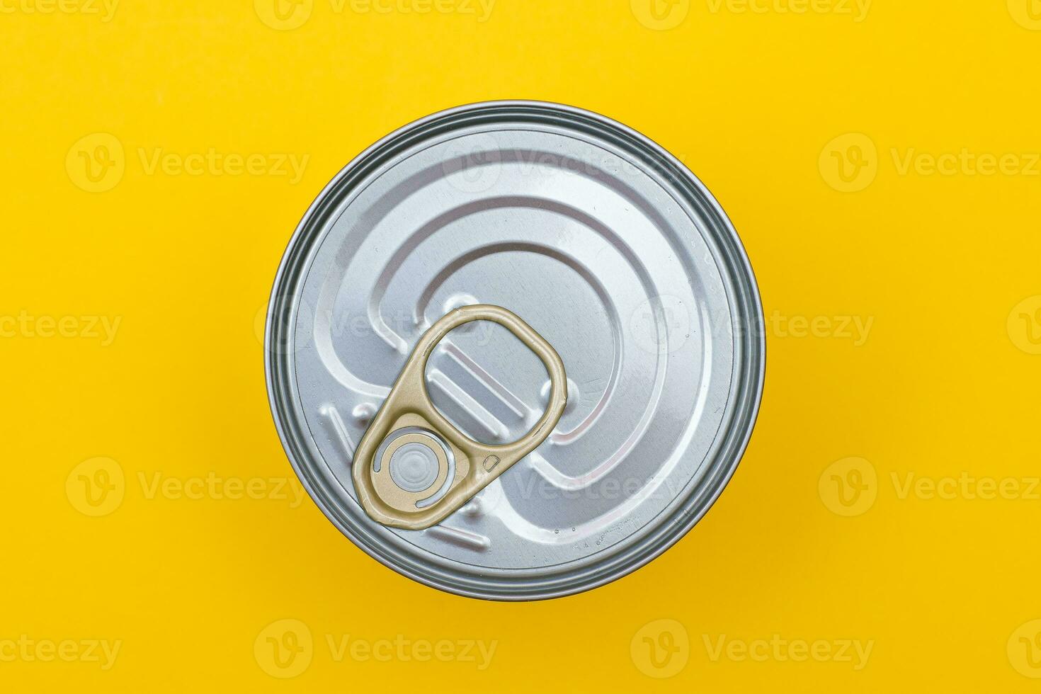 Unopened Tin Can with Blank Edge on Yellow Background. Canned Food. Aluminum Can for Safe and Long Term Storage of Food. Steel Sealed Food Storage Container photo