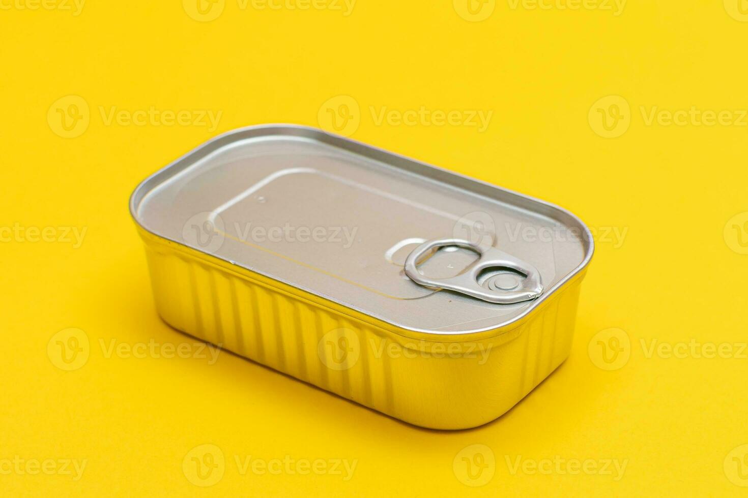 Unopened Tin Can with Blank Edge on Yellow Background. Canned Food. Aluminum Can for Safe and Long Term Storage of Food. Steel Sealed Food Storage Container photo