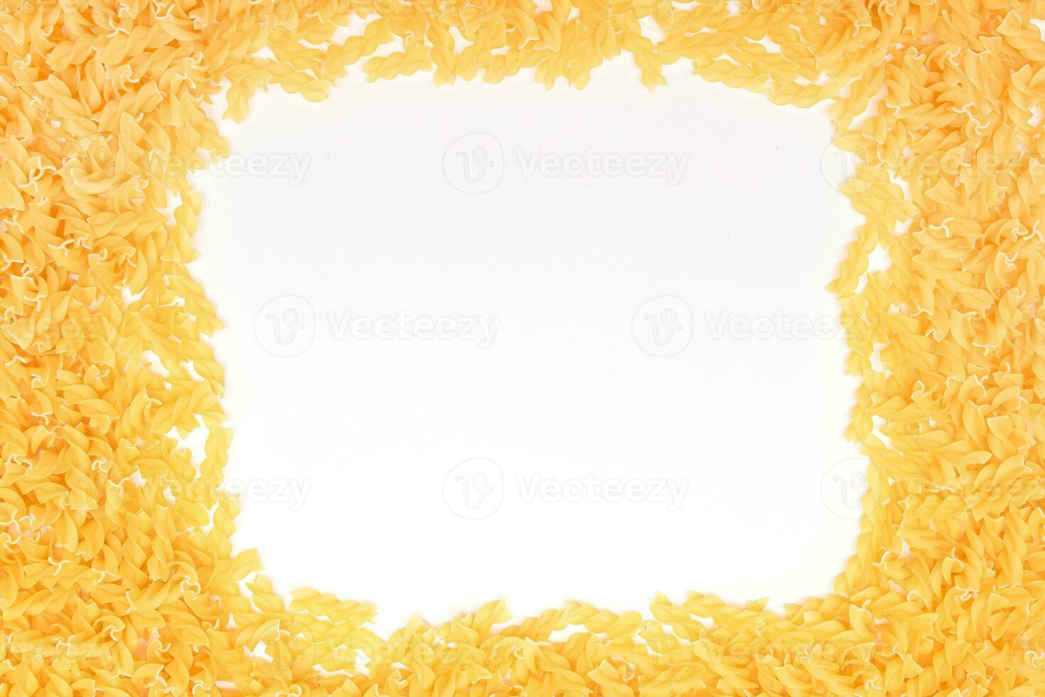 A Frame Made from Uncooked Fusilli Pasta Scattered on White Table Mock Up. Raw and Dry Macaroni. Unhealthy and Fat Food. Italian Culture photo