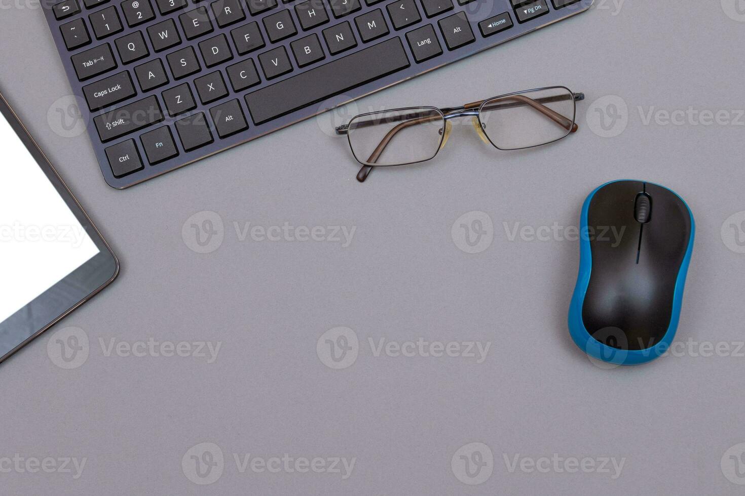 Top View of Workplace. Digital Gadgets Lying on Grey Table Flat Lay photo
