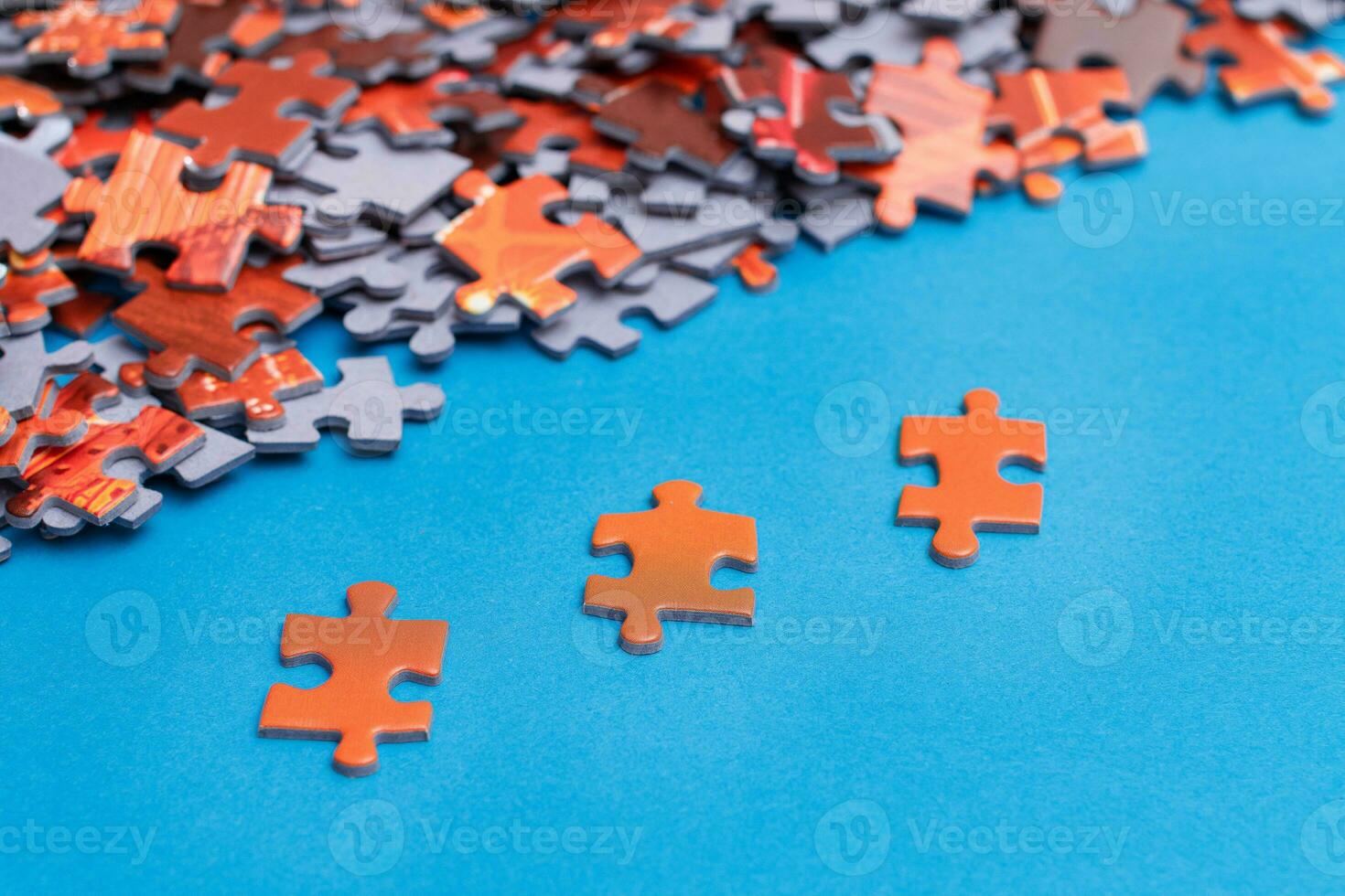 Mixed Peaces of a Colorful Jigsaw Puzzle Lie on the Blue Background Strategy and Solving Problem Concept photo