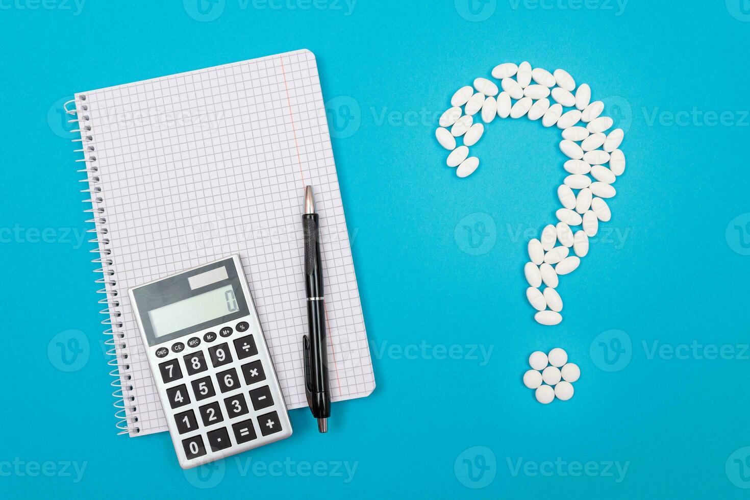 Treatment Costs and Budget. Question Mark Made from White Pills and Tablets with Calculator and Notepad, Lying on Blue Background. Global Pharmaceutical Industry and Medicinal Products photo