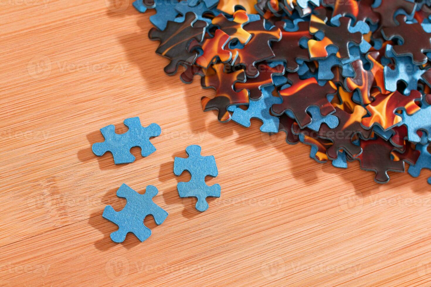 Colorful Peaces of a Mixed Jigsaw Puzzle Lie on the Wooden Table Strategy and Solving Problem Concept photo