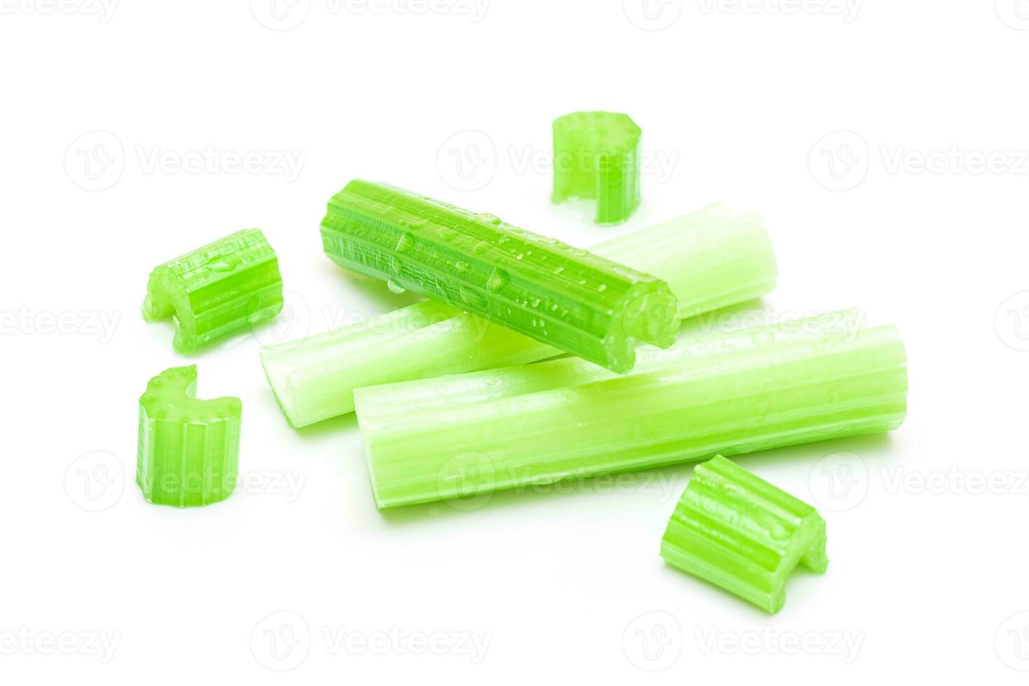 Fresh Chopped Celery Sticks and Slices with Water Drops Isolated on White Background. Vegan and Vegetarian Culture. Raw Food. Healthy Diet with Negative Calorie Content photo