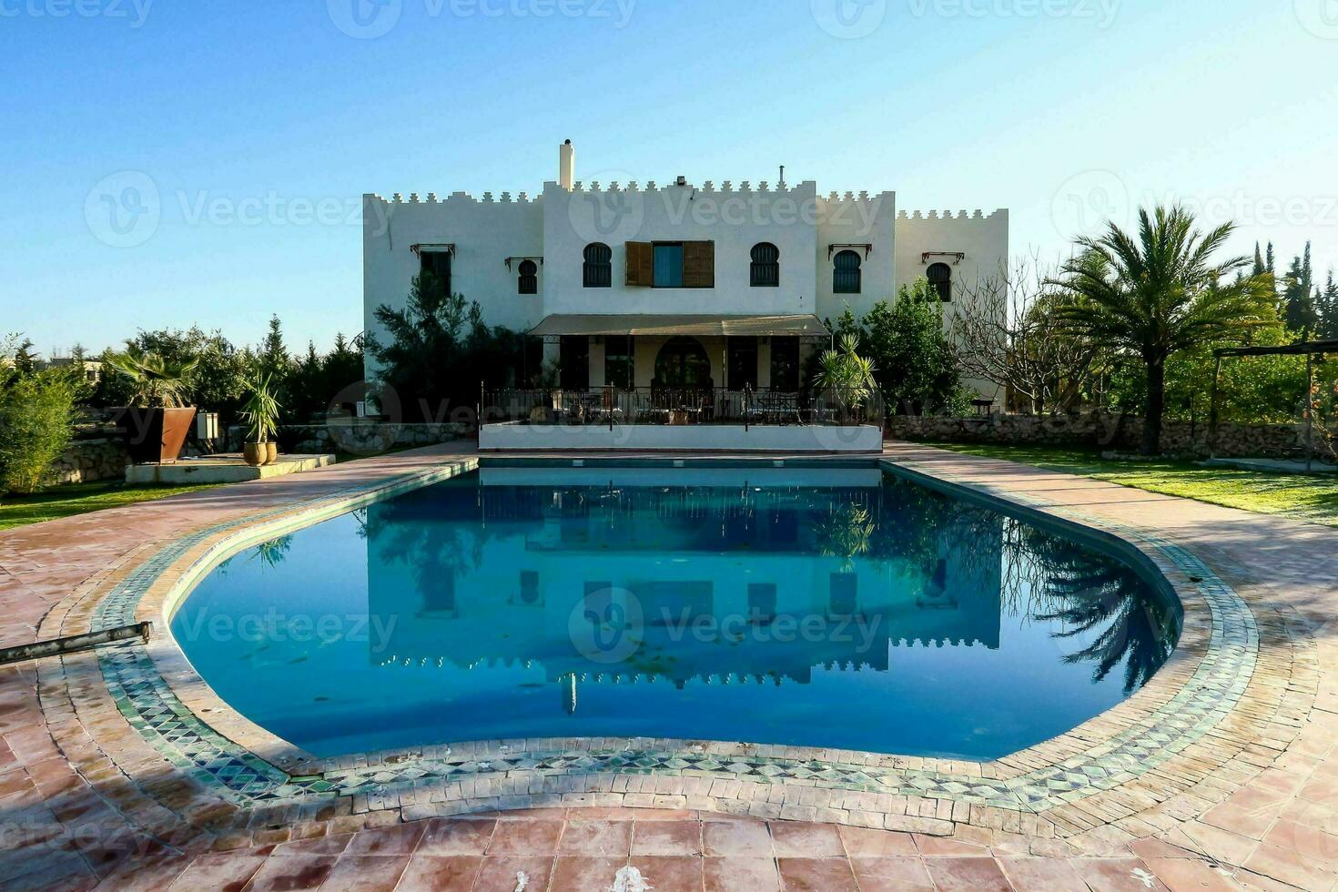 villa with pool in the middle of a large garden photo