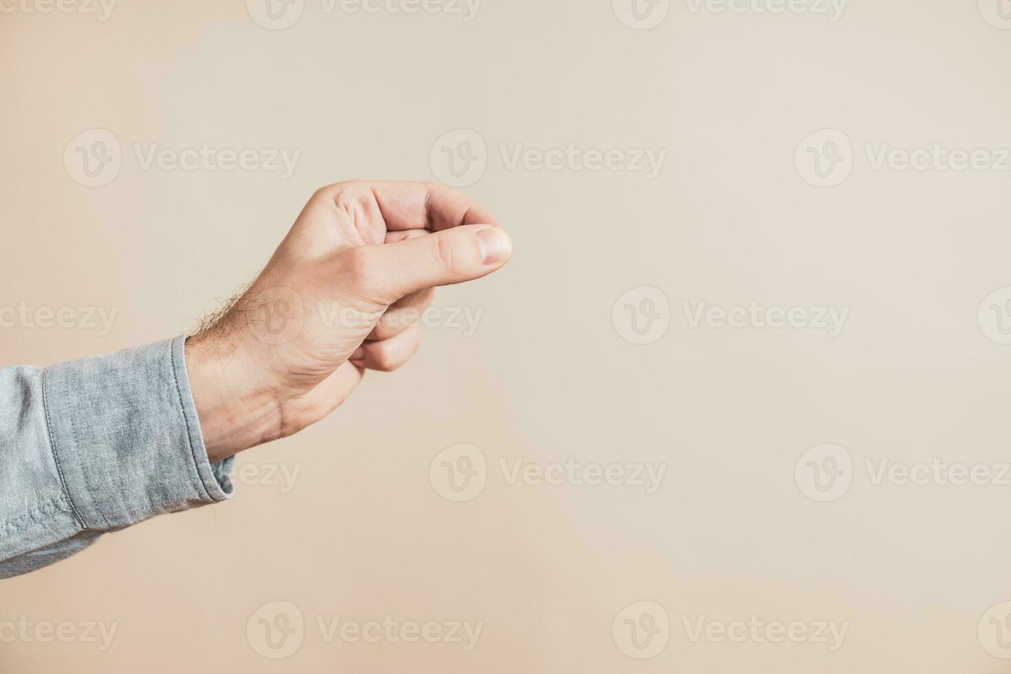 Close up image of male hand in picking gesture. photo