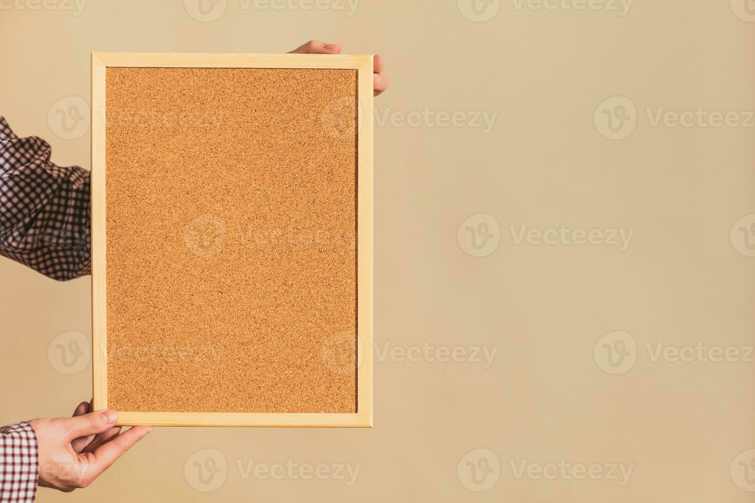 Image of man holding empty corkboard. photo