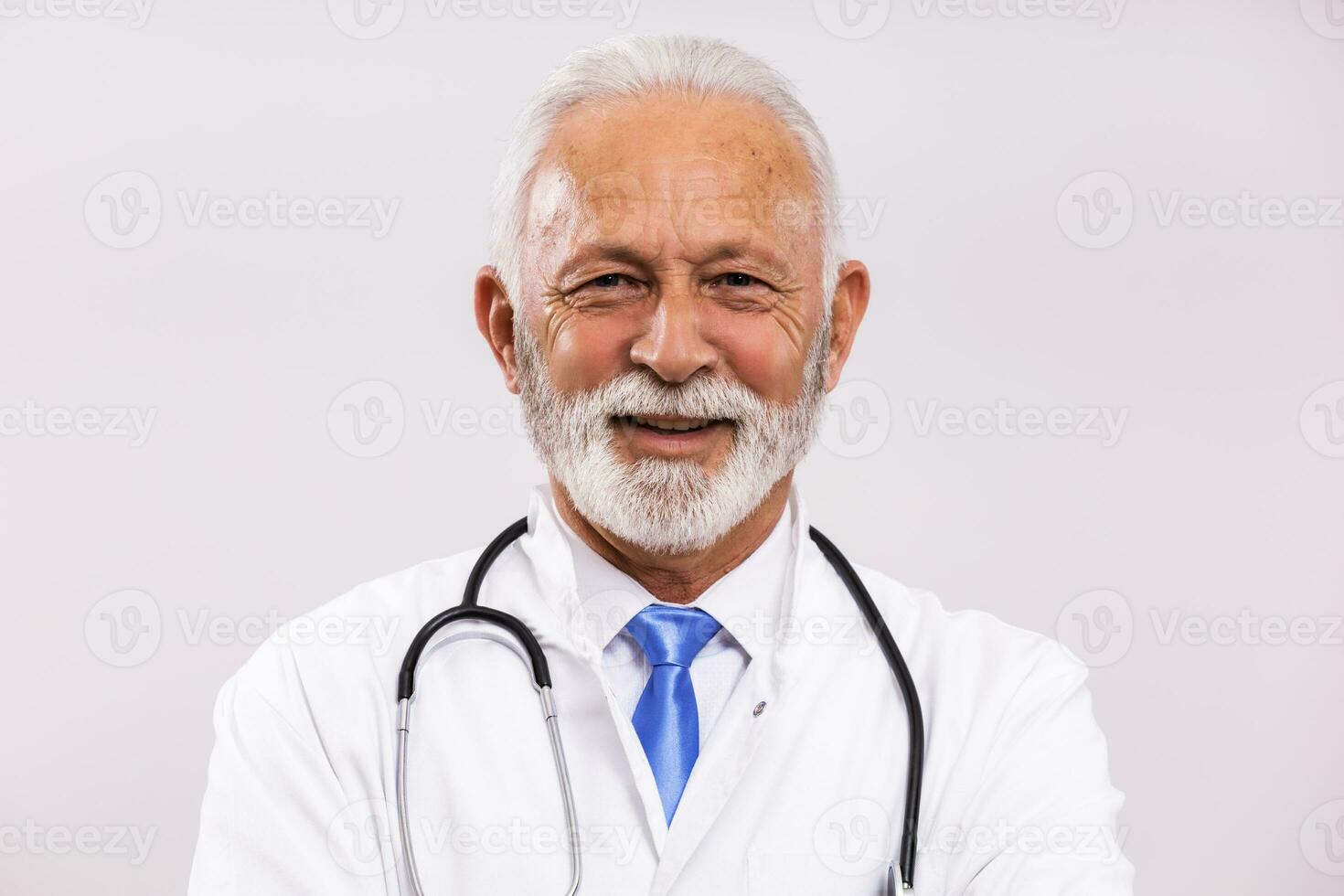 Portrait of senior doctor on gray background. photo
