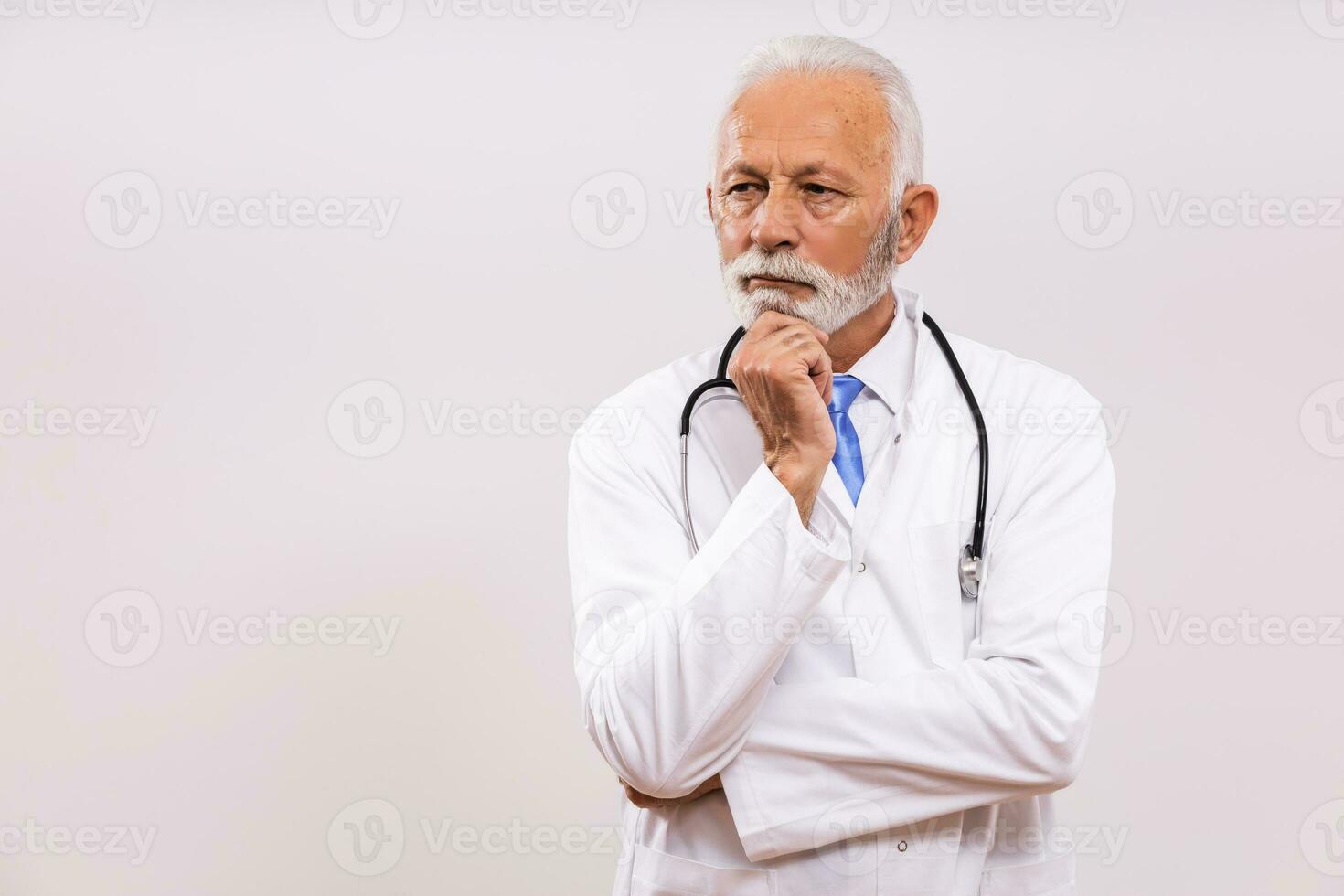 Image of worried  senior doctor thinking on gray background. photo