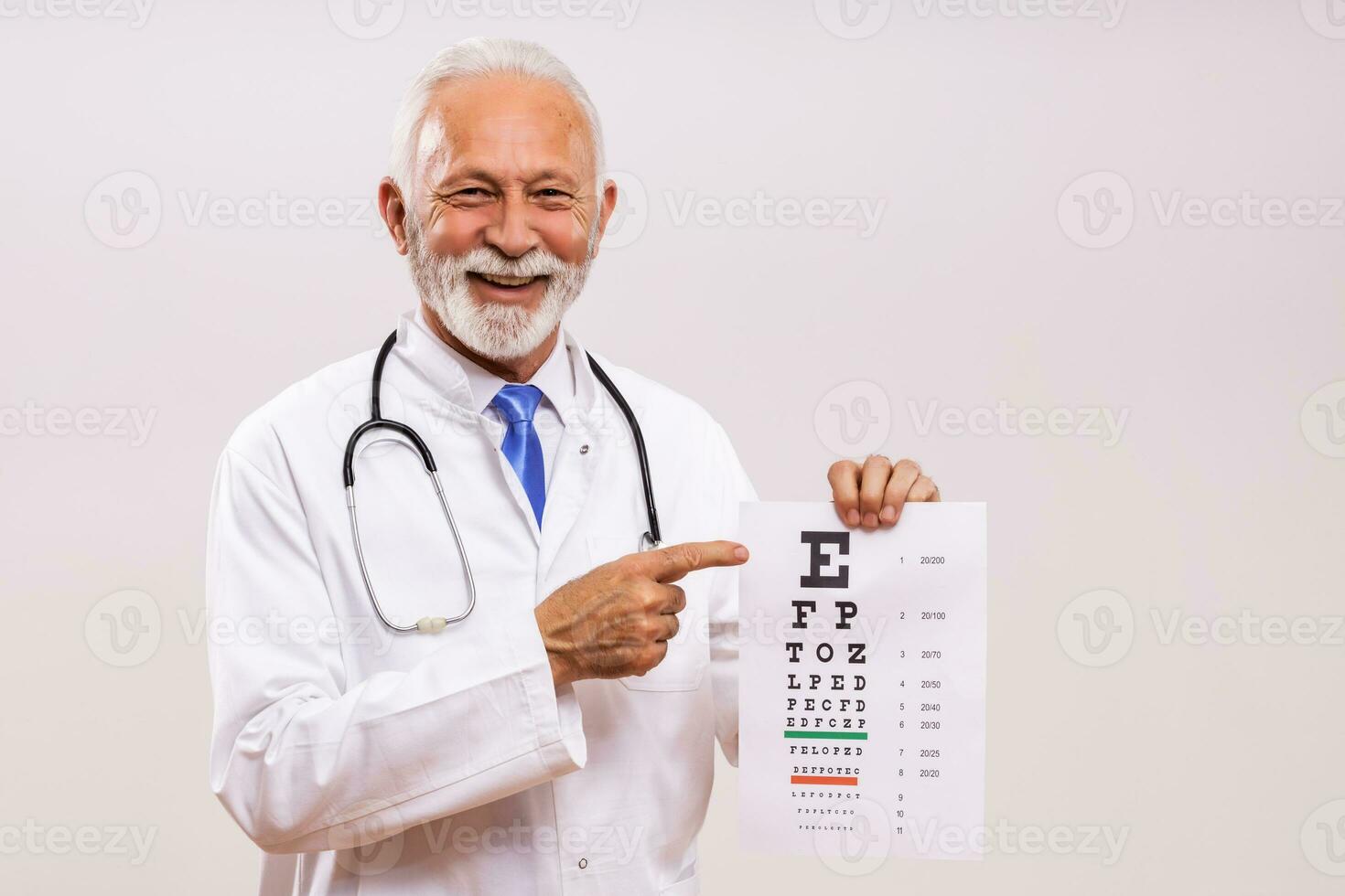 Portrait of  senior doctor doing eye exam. photo