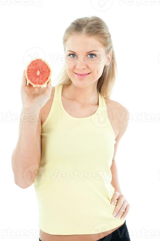 Sporty woman holding grapefruit photo