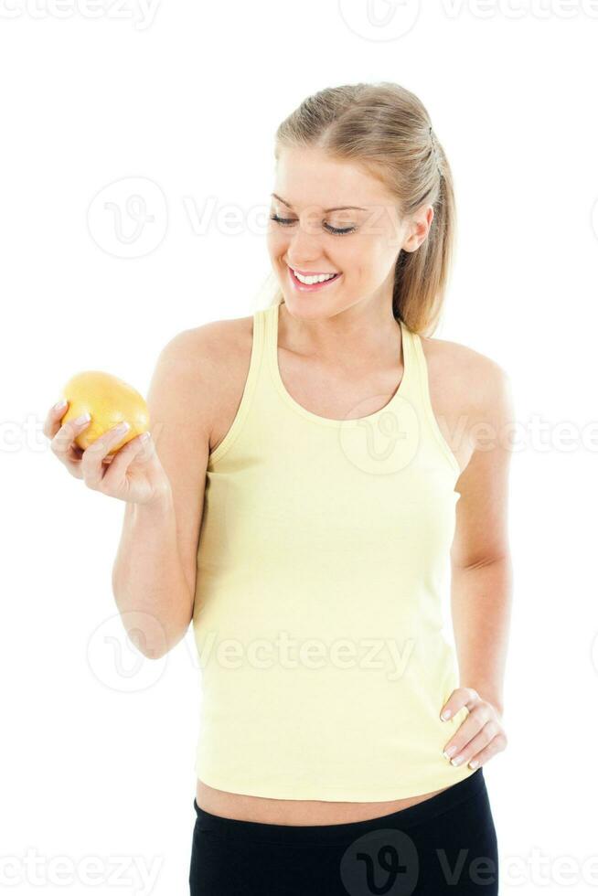 Sporty woman holding grapefruit photo