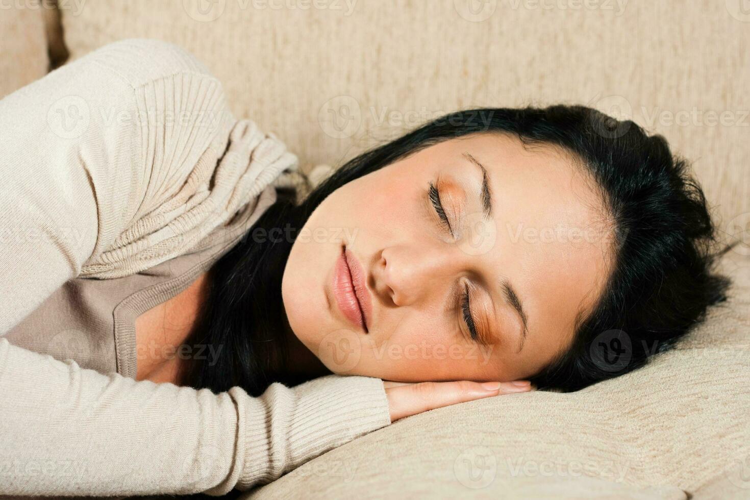 Woman napping at sofa photo