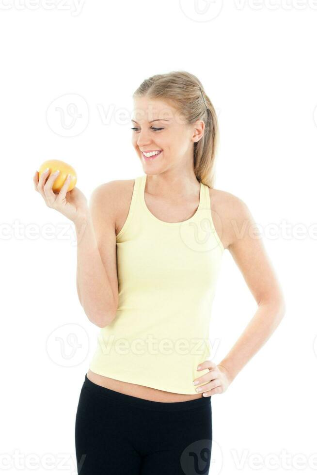 Sporty woman holding grapefruit photo