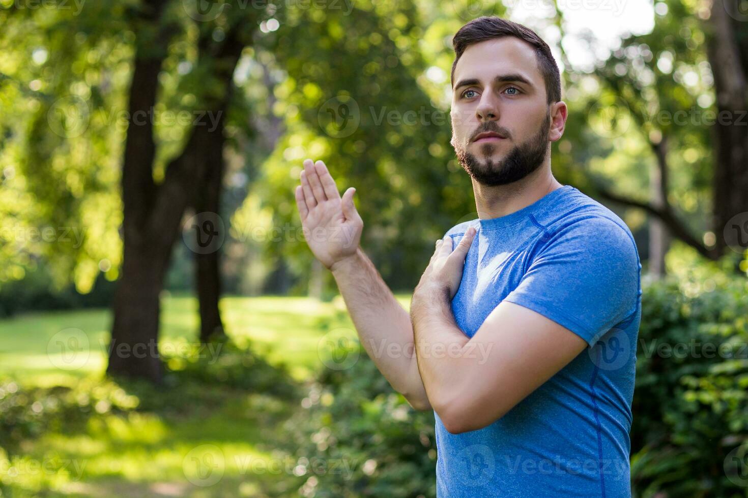 Handsome man exercising in the park. photo