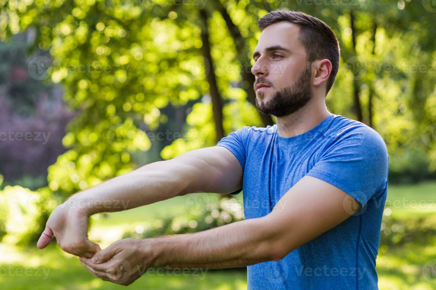 Handsome man exercising in the park. photo