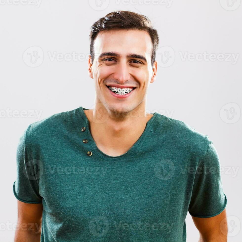 Portrait of young man with braces photo
