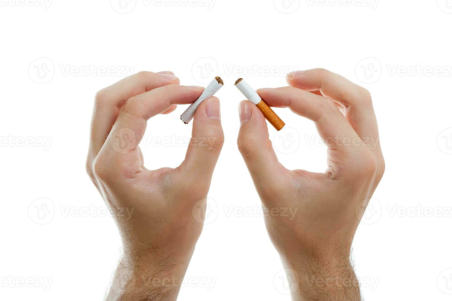 Close up of man hands holding broken cigarette photo