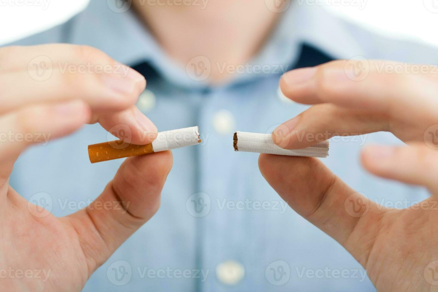 Man holding broken cigarette in his hand photo