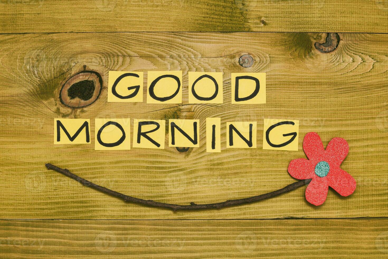 Image of text good morning and flower on wooden table.Toned photo