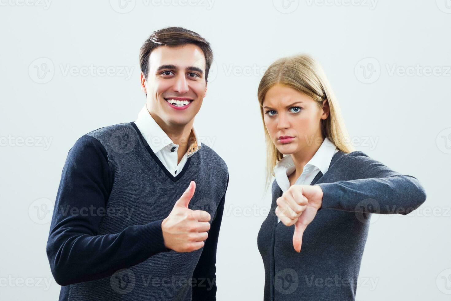 Businessman showing thumb up and businesswoman showing thumb down,.Competition at work concept photo