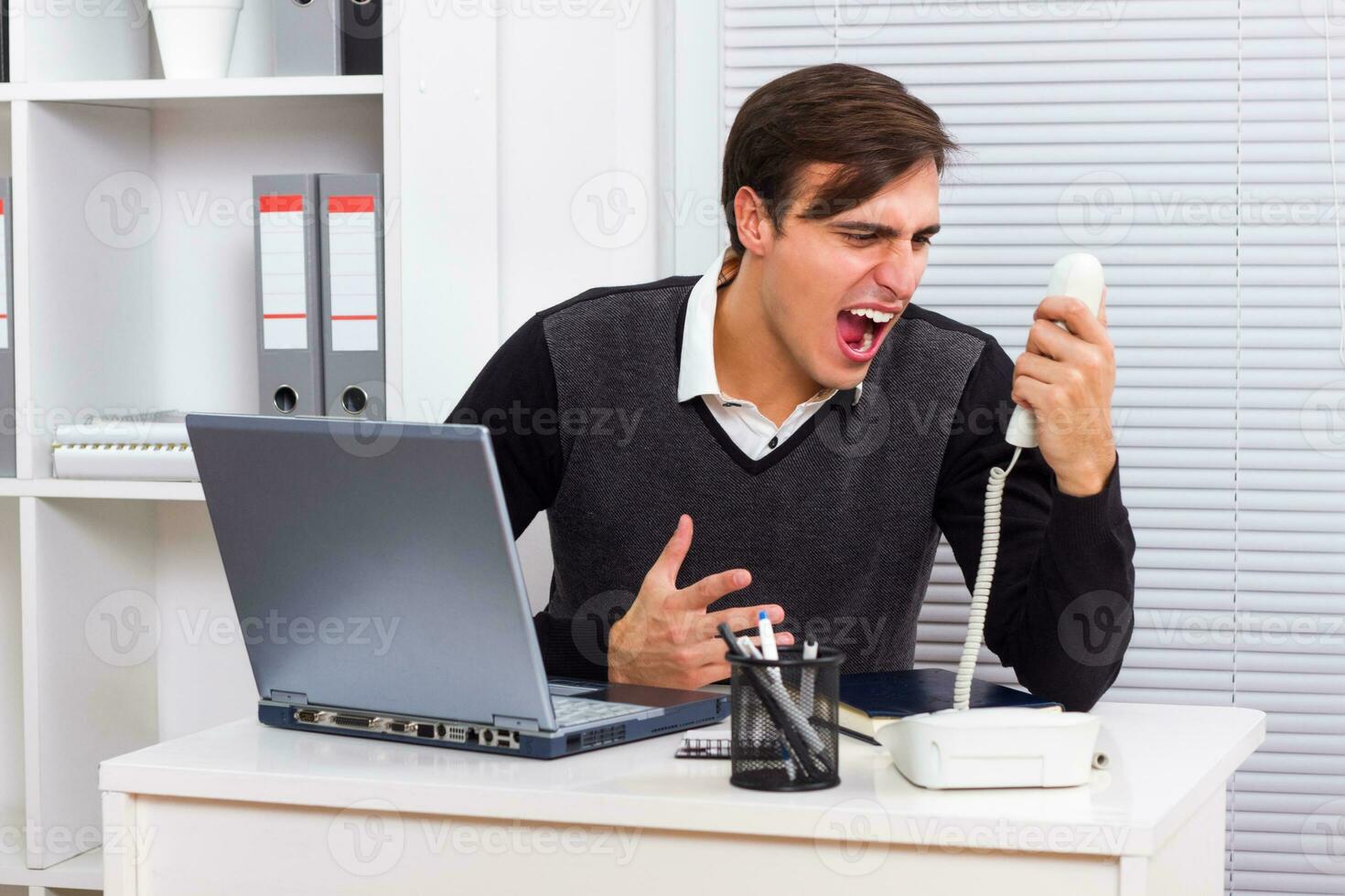Frustrated businessman shouting photo