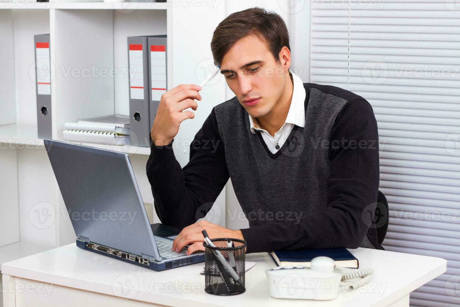 Businessman thinking while working photo
