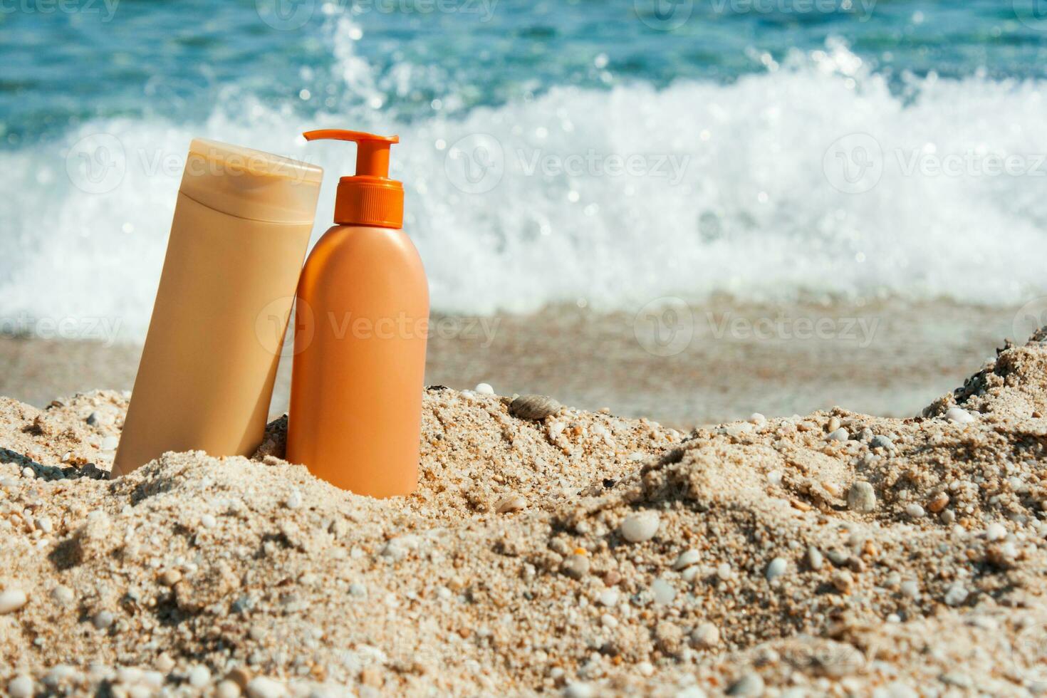 Suntan lotion  on the beach with a background sea waves photo