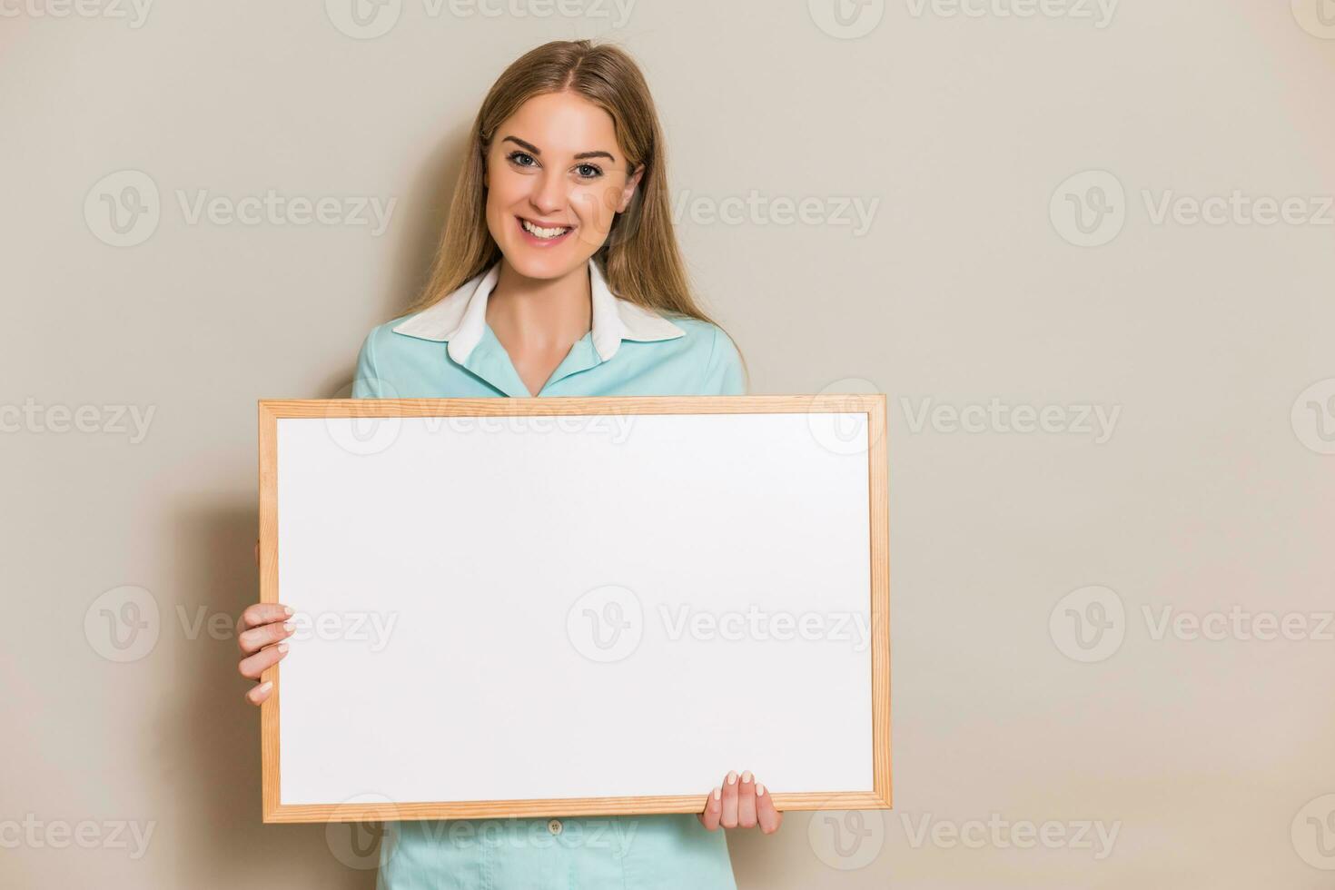 Portrait of medical nurse holding whiteboard. photo