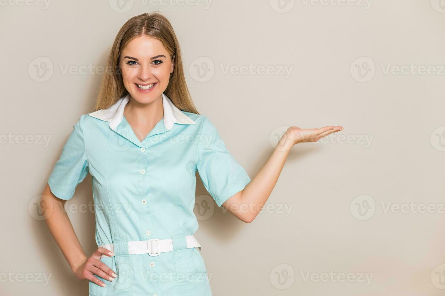 Portrait of medical nurse showing palm of hand. photo